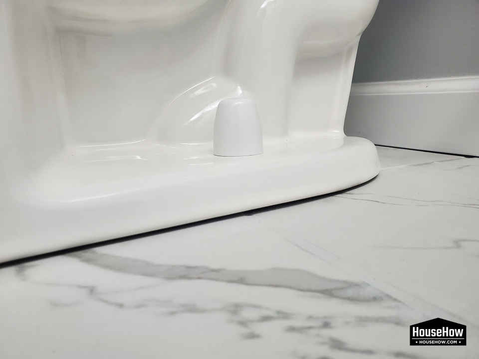 Many installers, out of pure laziness, do not silicone the base of the toilet after installing. Such a toilet can wobble and move as the screws and flange are often too weak to keep it in place. 